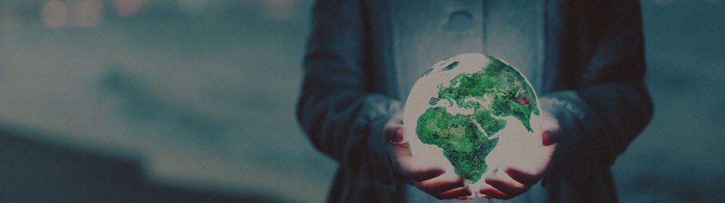 Woman holding glowing globe in her hands